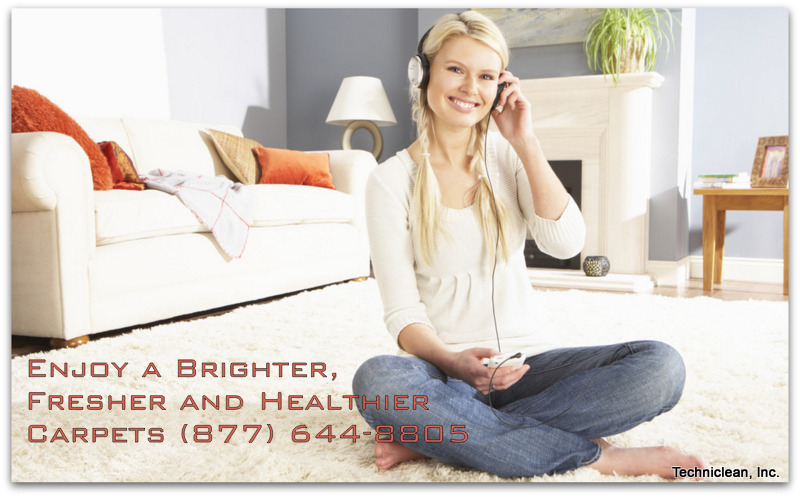 Woman Listening To MP3 Player On Headphones Relaxing Sitting On Rug At Home